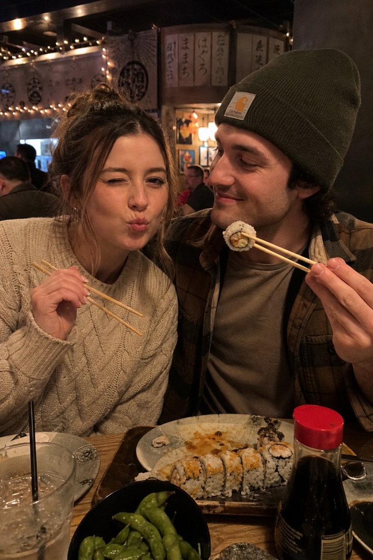 A couple sharing sushi on a date