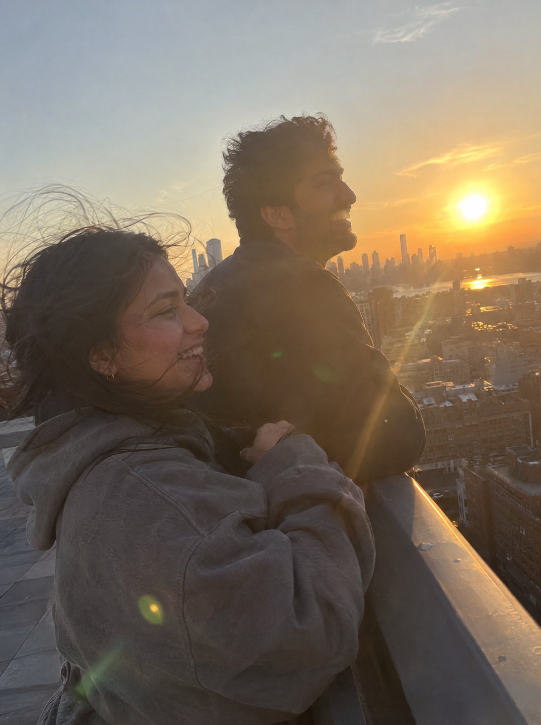 A couple on a rooftop at golden hour